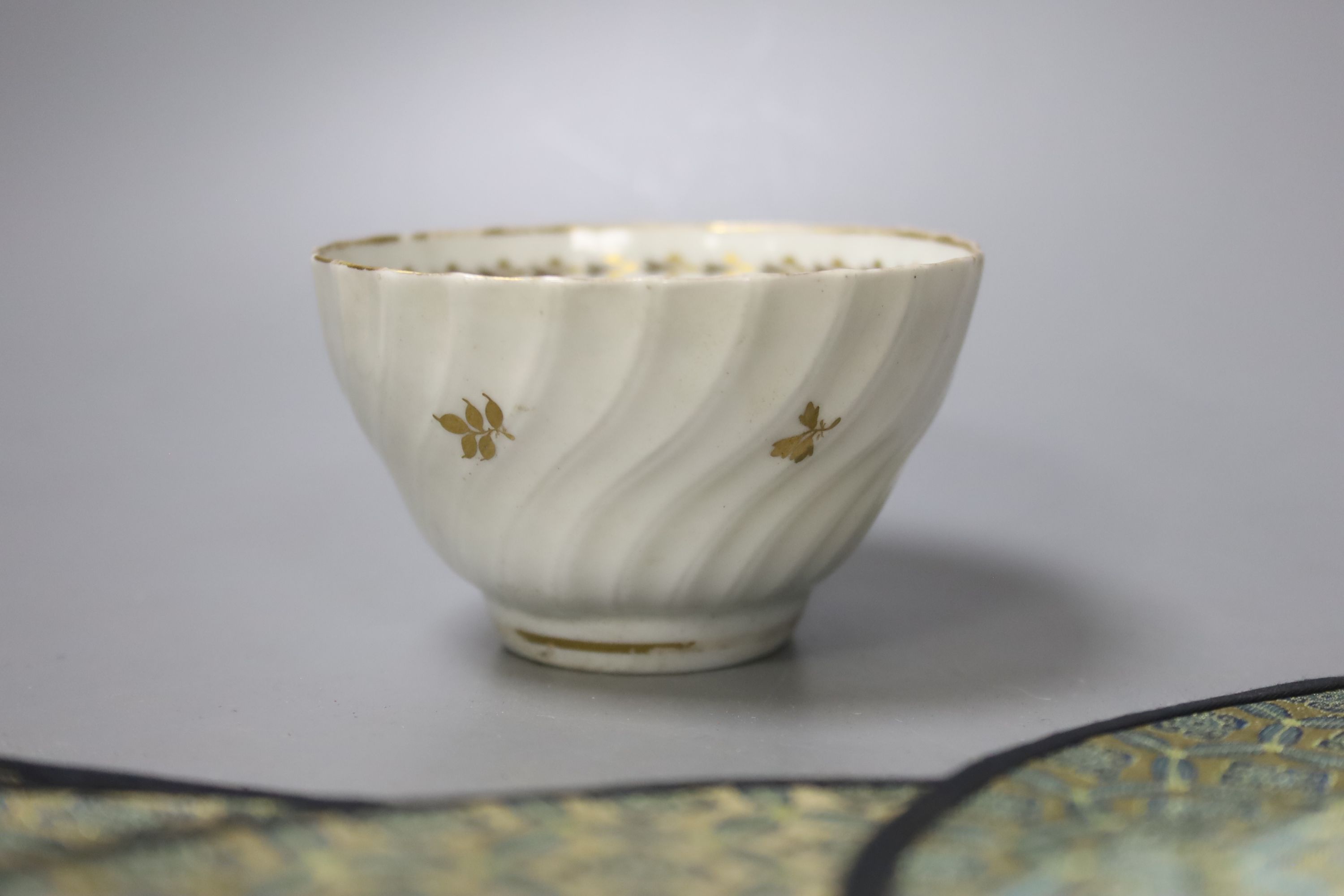 A Chinese porcelain brush pot, various embroidered silk mats etc.